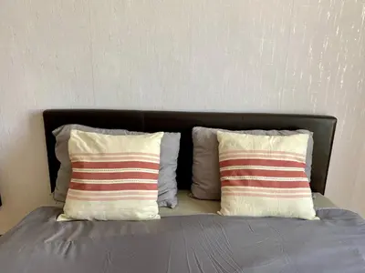 a bed with two pillows on top of it at Oldtown castle view apartment in Kaunas