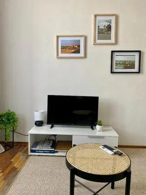 a living room with a tv and a table at Oldtown castle view apartment in Kaunas