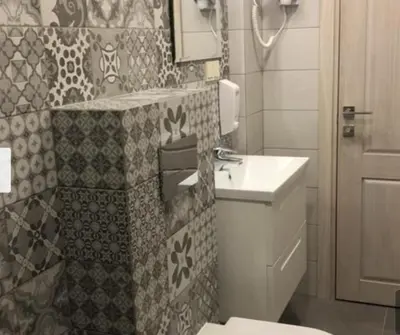 a bathroom with a toilet and a sink at HaPPy Inn Ugnė, The studio is in the heart of the old town, self-check-in, car-parking in Vilnius