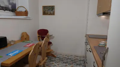 a kitchen with a table and chairs and a refrigerator at Druskininkų Pasaga in Druskininkai