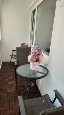 a table with a vase of flowers on it at Druskininkų Pasaga in Druskininkai