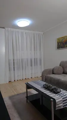 a living room with a couch and a coffee table at Druskininkų Pasaga in Druskininkai