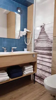 a bathroom with a sink and a large window with a beach view at Druskininkų Pasaga in Druskininkai