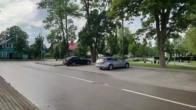two cars parked on the side of a street at Druskininkų Pasaga in Druskininkai