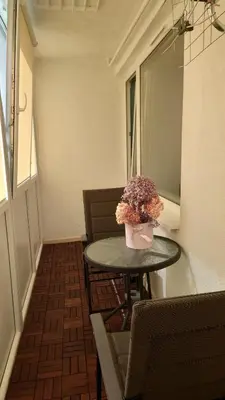 a small table with a vase of flowers on it at Druskininkų Pasaga in Druskininkai