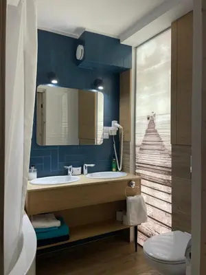 a bathroom with a sink and a view of a staircase at Druskininkų Pasaga in Druskininkai