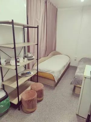 a bedroom with a bunk bed and two stools at Šaltupio kaimo turizmas in Pakumprys