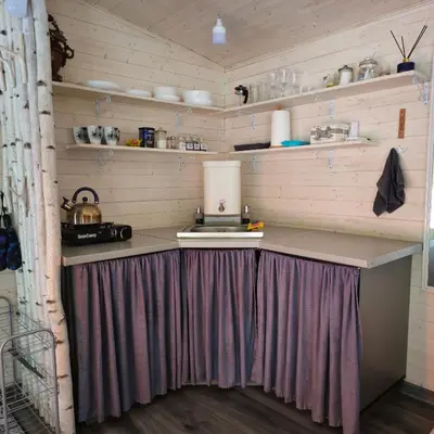 a kitchen with a table with a stage in it at Miško sielos namelis su pirtele in Aukštelkė
