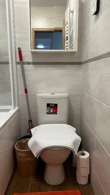 a bathroom with a toilet with a towel on it at Japandi apartamentai in Kaunas