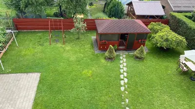 a model of a small house in a yard at Japandi apartamentai in Kaunas