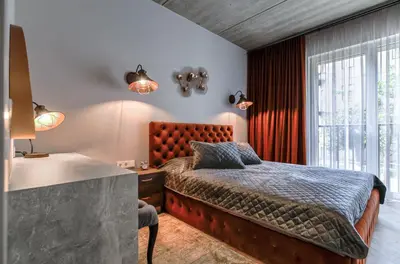 a bedroom with a large bed and a window at cohost I Nicely Designed NEW Apt w-Garage Parking & Self Check-in in Vilnius