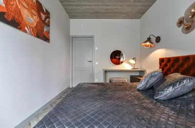 a bedroom with a large bed with two pillows at cohost I Nicely Designed NEW Apt w-Garage Parking & Self Check-in in Vilnius