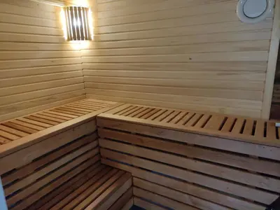 a small sauna with two wooden beds in it at Sodyba Valdo kubilas in Trakai