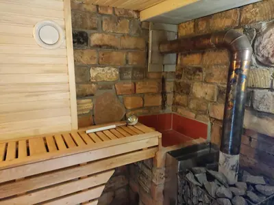 a sauna with a bench in a brick wall at Sodyba Valdo kubilas in Trakai