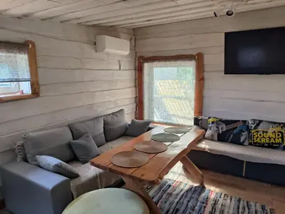 a living room with a couch and a table at Sodyba Valdo kubilas in Trakai
