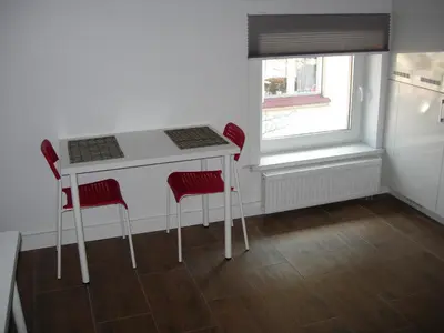 a kitchen with a table and two chairs and a window at Studio in Kaunas City in Kaunas