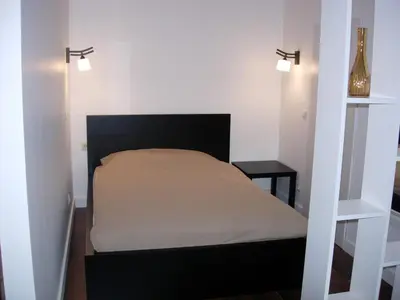 a bed in a small room with a bed sidx sidx sidx at Studio in Kaunas City in Kaunas