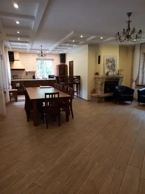 a living room with a table and chairs and a couch at My Forest Villa in Vilnius