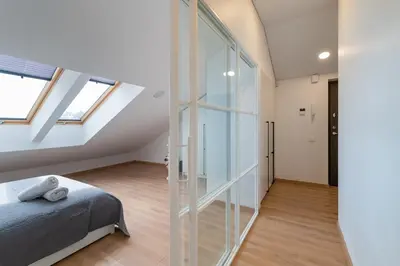 a bedroom with a bed and a glass wall at Spaciuos 1 BD Apt by Domvia in Kaunas