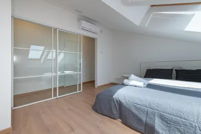 a bedroom with a bed and a glass wall at Spaciuos 1 BD Apt by Domvia in Kaunas
