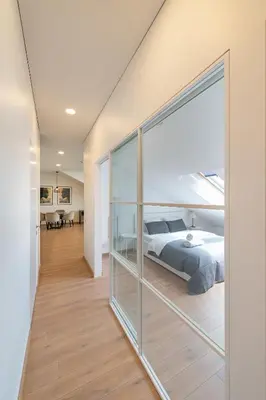 a bedroom with a bed and a glass wall at Spaciuos 1 BD Apt by Domvia in Kaunas