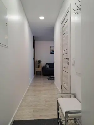 a hallway leading to a living room with a couch at Trumpalaikė apartamentų nuoma centre (Vytauto g.) in Šiauliai