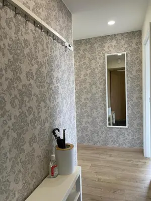 a bathroom with gray wallpaper and a mirror at Butas Anykščiuose šeimoms in Anykščiai