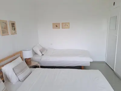 a room with two beds and a lamp in it at Butas Anykščiuose šeimoms in Anykščiai