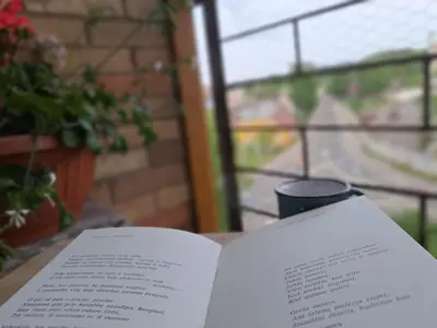 an open book sitting on a table with a window at Butas Anykščiuose šeimoms in Anykščiai