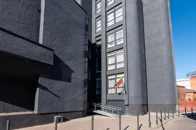 a building with a flag in front of it at Kaunas apartments near Bus station in Kaunas