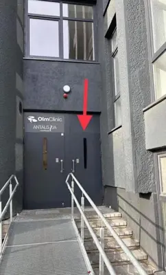 a door with a red arrow on the side of a building at Kaunas apartments near Bus station in Kaunas