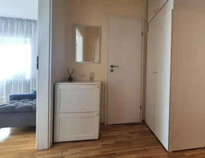 a room with a bedroom with a mirror and a door at Apartamentai Luna in Druskininkai