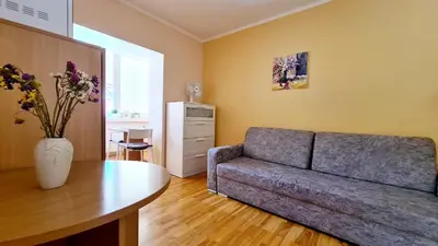 a living room with a couch and a table at Apartamentai Luna in Druskininkai