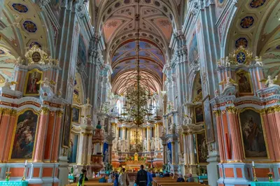 a large church with ornate ceilings and a chandelier at Picturesque Old Town Apartment with Charming Balcony in Kaunas