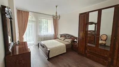 a bedroom with a bed and a dresser and a mirror at Vakaro Namai in Alytus