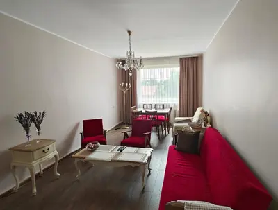 a living room with a red couch and red chairs at Vakaro Namai in Alytus