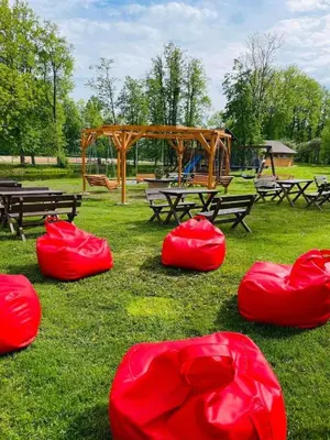 a park with a picnic table and a playground at Obuoliu sala Moletu Vila in Gaylyunay
