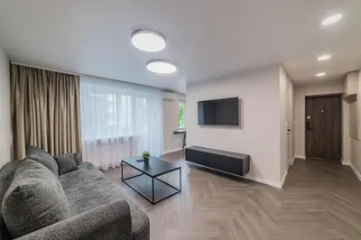 a living room with a couch and a flat screen tv at Frida Apartment in Šiauliai