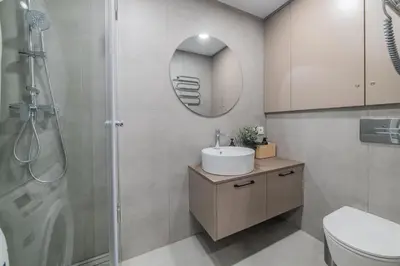 a bathroom with a sink and a shower at Frida Apartment in Šiauliai
