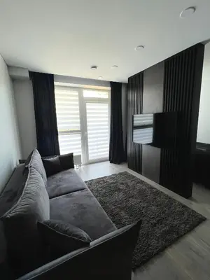 a living room with a couch and a flat screen tv at J.Kairiūkščio apartamentai in Vilnius