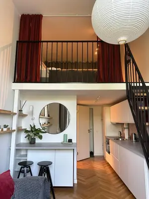 a small apartment with a staircase and a living room at M Loft2 in Kaunas