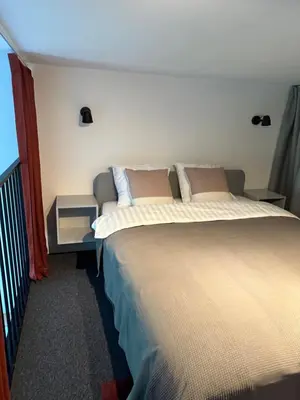 a bedroom with two beds and a window at M Loft2 in Kaunas