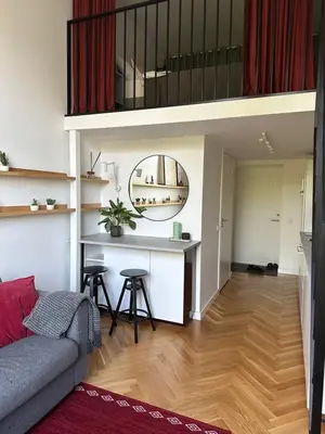 a living room with a couch and a table at M Loft2 in Kaunas