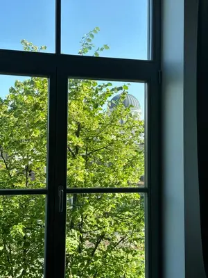 a window with a view of the olympics seen through it at M Loft2 in Kaunas