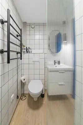 a bathroom with a toilet and a sink at Mini Loft 1 BD Apt by Domvia in Kaunas