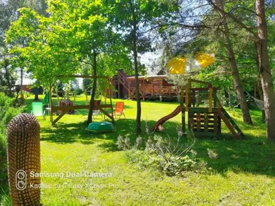 a park with a playground with a slide at Taparynė in Alanta