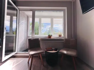 two chairs and a table in front of a window at Lovely Stay in Siauliai in Šiauliai