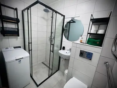 a bathroom with a shower and a toilet and a sink at Lovely Stay in Siauliai in Šiauliai