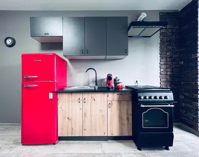 a kitchen with a red refrigerator and a stove at Lovely Stay in Siauliai in Šiauliai