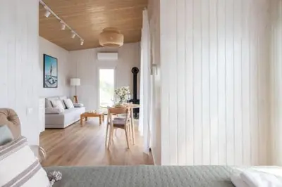 a living room with a couch and a table at Pineplace twins Smilga in Žaugėdai
